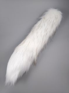 the tail of an animal that is white and has long, fluffy fur on it