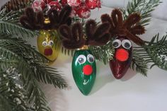 three christmas ornaments hanging from a tree with red noses and nose decorations on it's branches