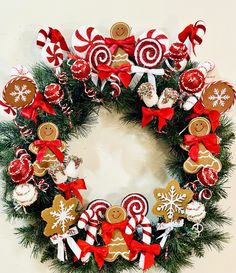 a christmas wreath with gingerbreads, candy canes and candies on it