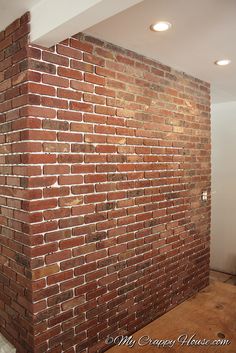 a brick wall in the corner of a room