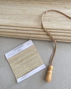 a close up of a wooden object on a table next to a paper with a name tag