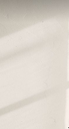 a black and white cat sitting on top of a window sill next to a potted plant