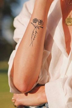 a woman with a flower tattoo on her arm