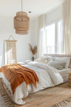 a large bed sitting in a bedroom on top of a wooden floor next to a window