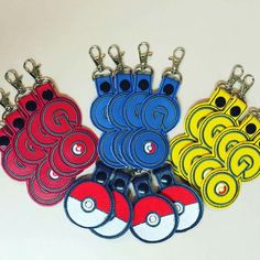 several key chains with different colors and designs are shown in the shape of pokemon pikachu