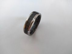 Obsidian ring, Raw stone ring, Wedding ring, Mens band, His and hers, Black stone, Womens ring, Engagement, Promise, Gift, Natural jewelry. The photo ring is 7mm width. Please, let me know the width (and any other specification) of the ring you are going to buy in the note to seller at the time you make your purchase! widths from 3 mm to 9 mm. Stone and wood are my favorite materials for making rings. These two natural elements give to the jewels the unique character of a piece manufactured by hand. The process for manufacturing this titanium band ring with Toumaline reconstituted inside consists of grinding a piece of natural Tourmaline to obtain small pieces and powder, in this way you get a beautiful play black. This ring is unique and original and the inside of the stone is covered by Black Titanium Anniversary Rings, Obsidian Wedding Band, Unisex Rings, Making Rings, Black Obsidian Stone, Obsidian Ring, Photo Ring, Raw Stone Ring, Obsidian Stone