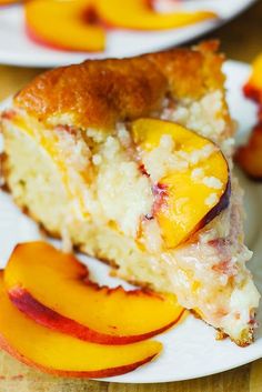 a piece of cake on a plate with sliced peaches