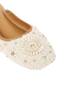 Perle is one of the most prestigious pairs from our collection. Fit for every girl! With an open back, this pair is classy, elegant and graceful. Set on a white base, studded with elegant creamy pearls that makes a beautiful flower in the middle and clustered with silver rhinestones that adds a graceful sparkle to the whole shoe. Gift it to your loved ones on their special days and feel the true essence of love. Color: White Fabric: Leather Upper- leather - leather lining cushion for extra comfo Elegant Beige Flats For Summer, Chic Summer Wedding Flats, Elegant Pearl Embellished Formal Flats, Elegant Pearl Embellished Flats For Formal Occasions, Elegant Pearl-embellished Formal Flats, Embellished Flats With Flat Heel For Formal Occasions, Elegant Fitted Closed Toe Flats, Elegant Cream Flats For Summer, Chic Almond Toe Wedding Flats