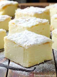 several pieces of cake sitting on top of a cooling rack covered in powdered sugar