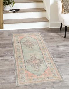 an area rug on the floor with stairs in the background