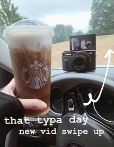 someone is holding up a starbucks drink in their car with the words, that type day new video up