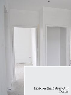 an empty room with white walls and carpet