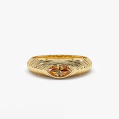 This 14k Gold step beveled ring features a radiant 7x3.5 MM marquise cut Citrine, the birthstone for November. The ring has a modern design, perfect for everyday wear, and the Citrine gemstone adds a pop of color to the piece. The step beveled design adds depth to the ring and the 14k Gold gives it a touch of luxury. This ring is perfect for anyone born in November or anyone who loves the color yellow. Features: * Made to Order * Gold Kt: 14K Solid Gold (also available in 18K) * Available Gold Colors: Rose Gold, Yellow Gold, White Gold * Marquise Citrine: 1 pc 7 x 3.5 MM * Citrine Carat Weight: 0.35 ctw * Ready to Ship in 7-10 Business days  ▶ See more of our Gemstone Jewelry here- https://etsy.me/3CGRdMI ▶ See our storefront here - http://etsy.me/2lUcVnH  ▶ All store sections here * Diamo Luxury Faceted Yellow Gold Rings, November Birth Stone Rings, Luxury Gold Marquise Signet Ring, Beveled Ring, Citrine Ring Engagement, November Birthstone Ring, Slouch Socks, Marquise Ring, Gold Armband