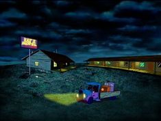 a truck parked in front of a building at night