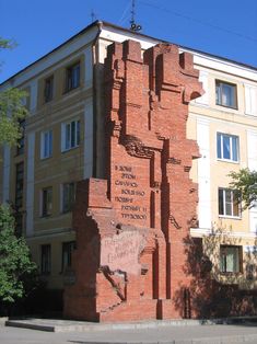 a tall brick building sitting on the side of a road