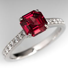 a red diamond ring with white diamonds on it