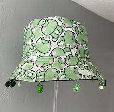 a green and white hat with elephants on it