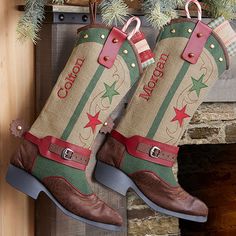 two christmas boots hanging from a mantel