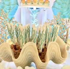 there is a cake in the shape of an ocean wave with seaweed on it