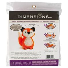 an orange and white stuffed animal sitting on top of a plastic bag with instructions to make it