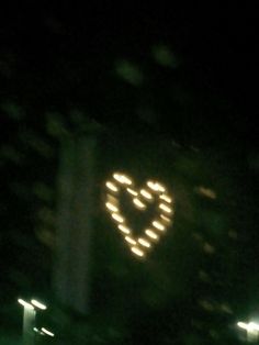 a lighted heart on the side of a building