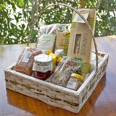 a basket filled with food sitting on top of a wooden table