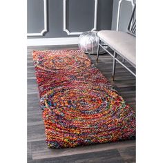 a multicolored rug on the floor in a room