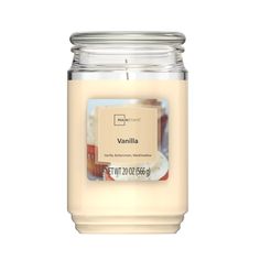 a candle that is sitting on top of a white surface with the words vanilla in front of it