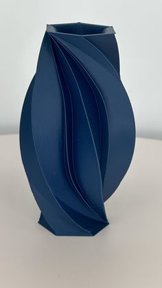 a blue vase sitting on top of a white table