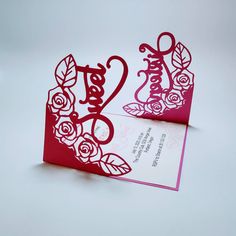 a red and white wedding card with roses on it