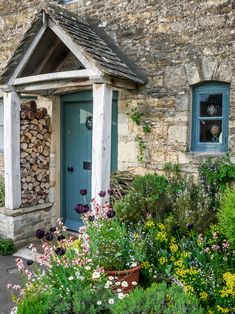 an image of a small house with flowers and plants around it