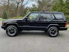 a black jeep is parked on the street