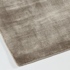 a close up view of an area rug on a white surface with no one in it