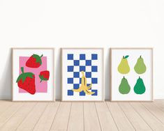 three framed art prints with different fruits and vegetables on them in front of a white wall