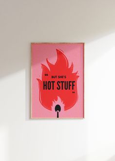 a pink poster with the words hot stuff on it in front of a white wall