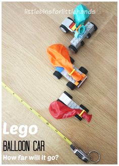 two toy cars sitting on top of a wooden floor next to a tape measure line