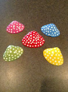 four polka dot rocks sitting on top of a table