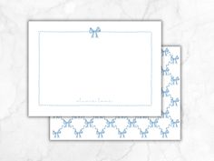 two cards with bows on them, one is blue and the other has white paper