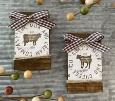 two wooden signs with farm animals on them