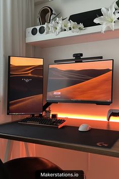 two computer monitors sitting on top of a desk