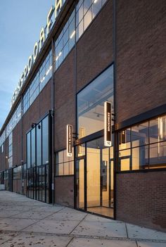 the entrance to an industrial building with large windows