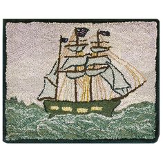 a rug with a ship on it in the water