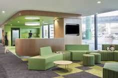 an office lobby with green and yellow furniture