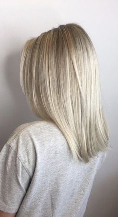 the back of a woman's head, with blonde hair and long straight bangs