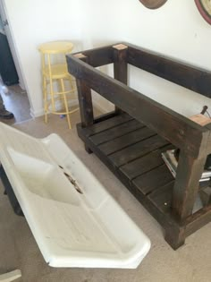 a bathtub and sink in a room with a clock on the wall behind it