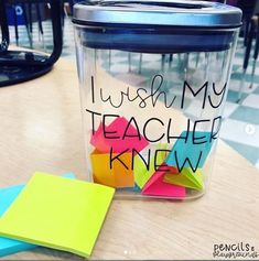 a jar that has some sticky notes in it and is sitting on a table next to a pair of scissors