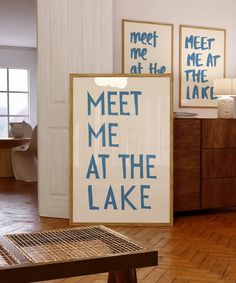 there is a sign that says meet me at the lake in front of two pictures