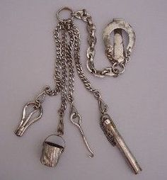 an assortment of silver items on a chain