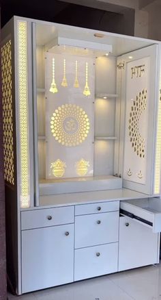 a white cabinet with gold designs on it