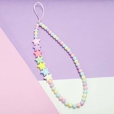 a necklace with pastel colored beads and stars on it